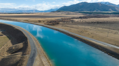 Aerial view of the Pukaki hydro power scheme canal running in parallel with the Ben Ohau mountain rangeの写真素材