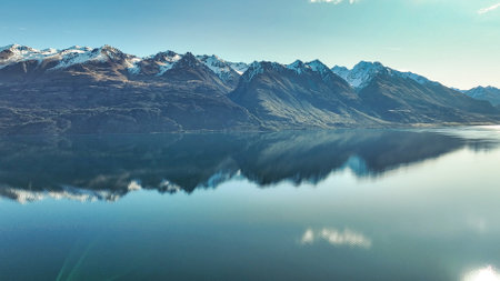Dreamy aerial view from a mavic drone of the shoreline  of lake Wakatipu and its surrounding mountain rangesの写真素材