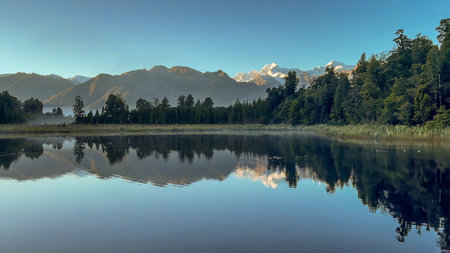 Small lake surrounded by forest famous for its southern alps lake reflections