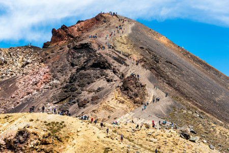 Queue of people on the crossing descending from Red Crater to the Emerald Lakes on the Tongariro alpine trackの写真素材
