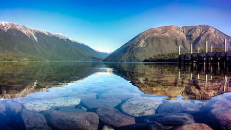 Mirror reflections on the Forest enclosed Lake Rotoiti at St Arnaud Nelsonの写真素材