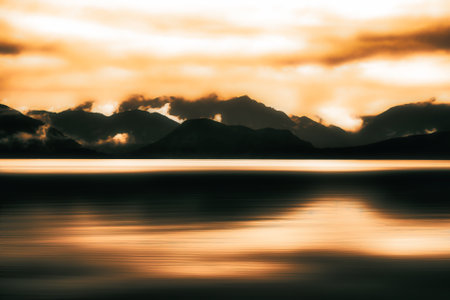 Mysterious atmospheric reflections on Lake Kaniere on a dark afternoonの写真素材