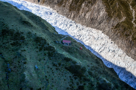 Aerial view of the glacier and the house in the mountains.の写真素材