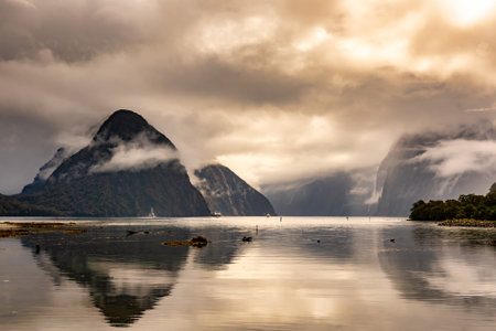 Mitre peak reflections under a dramatic cloudscape at  Milford Soundの写真素材