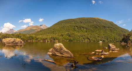 Reflections on a tranquil alpine lake near the Dart and Rees rivers in Glenorchy countryの写真素材