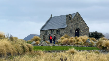 Man and Woman standing on the grounds of the Tekapo Chapelの写真素材