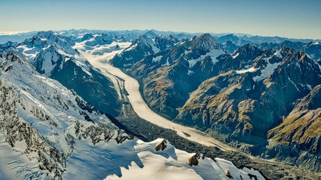 Flying over the southern alps mountain range snow covered peaks