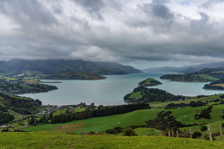 Aerial view of a large body of water surrounded by green hills and mountains.