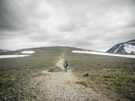 Man doing trekking on the wild Besseggen Ridge, Norwayの写真素材