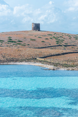 Old tower and beautiful beach in Asinara island, Sardinia, Italyの写真素材