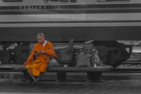 BANGKOK, THAILAND, 12 JANUARY 2020: Monk waiting for its train in Bangkok Train Station