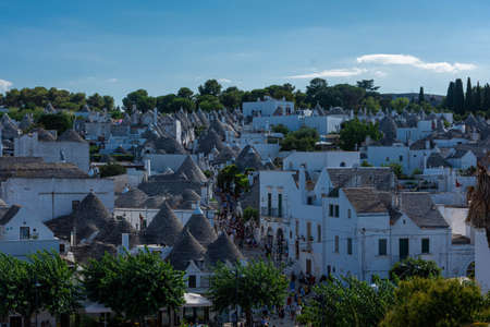 ALBEROBELLO, ITALY: Tourists in Alberobello, town with typical houses called "trulli" in Puglia, southern Italyの写真素材