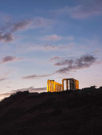 The Temple of Poseidon at Cape Sounion at sunset, over the Aegean Sea in Greeceの写真素材