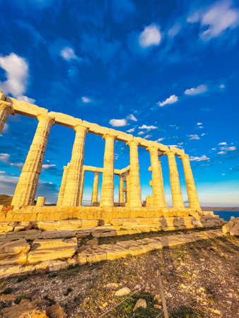 The Temple of Poseidon at Cape Sounion at sunset, over the Aegean Sea in Greeceの写真素材
