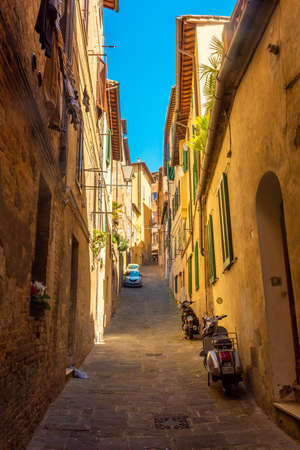 Siena, Italy, 17 April 2022: typical street scene of the medieval historic centerのeditorial素材