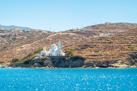 White church on a cliff over the Aegean Sea in Sikinos Island, Greeceの写真素材