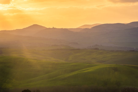 Amazing sunrise over the green hills of the Tuscany countryside, Italyの写真素材