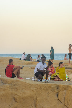 Sliema, Malta, 22 May 2022: Young people having fun on the coast of Sliema bay at sunsetのeditorial素材