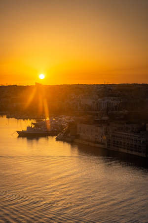 Beautiful sunset over the bay of Valletta, Maltaの写真素材
