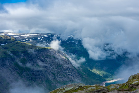 Moody foggy landscape in the mountains of Trolltunga, Norwayの写真素材