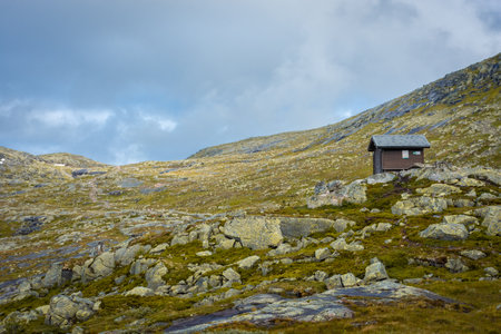 Wooden hut in the Norwegian mountains, moody landscape in the trail for Trolltungaの写真素材