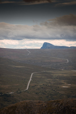 Lonely road passing through the tundra of Jotunheimen National Park, Norwayの写真素材