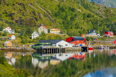 Perfect reflection of the Reine village on the water of the fjord in the Lofoten Islands, Norwayの写真素材