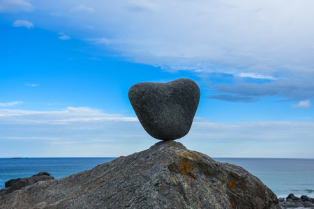 Heart-shaped rock on a sea stack in Uttakleiv Beach, Lofoten Islands, Norwayの写真素材