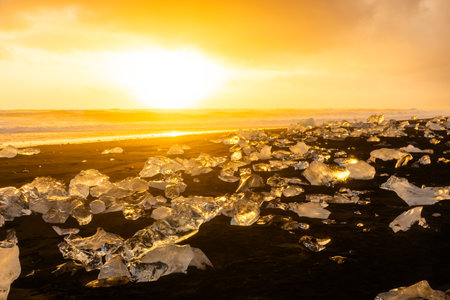 Amazing sunset over the Diamond Beach, volcanic black beach with icebergs from the Jokulsarlon glacier lagoon, Icelandの写真素材