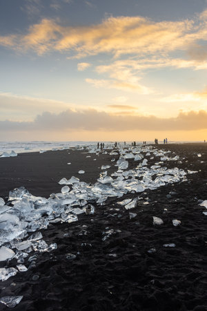 Amazing sunset over the Diamond Beach, volcanic black beach with icebergs from the Jokulsarlon glacier lagoon, Icelandの写真素材