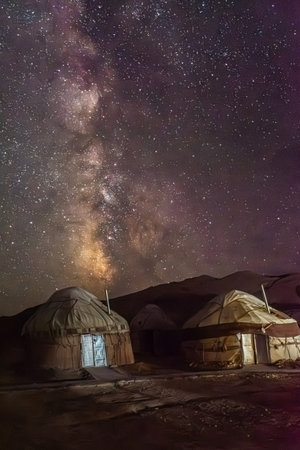 Amazing milky way and starry night over a yurt camp in the Aral Lake desert, Uzbekistanの写真素材