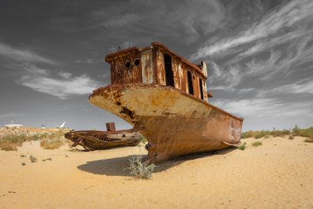 Muynak, Uzbekistan 16 August 2023 : Rusting shipwrecks on what used to be the seabed of the Aral Sea. The Aral Sea has lost significant amounts of water coverage due to excessive irrigationの写真素材