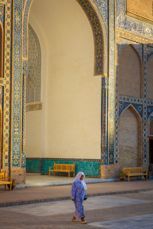 Samarkand, Uzbekistan, 10 August 2023: Woman in traditional clothes in front of the Gur i Amir Mosqueの写真素材
