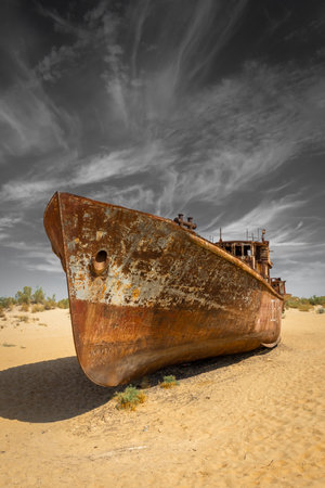 Muynak, Uzbekistan 16 August 2023 : Rusting shipwrecks on what used to be the seabed of the Aral Sea. The Aral Sea has lost significant amounts of water coverage due to excessive irrigationの写真素材