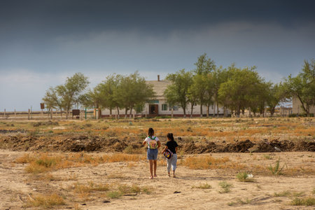 Karakalpakstan, Uzbekistan, 18 August 2023: The only two children of the village Qubla-Ustyurt going to schoolの写真素材