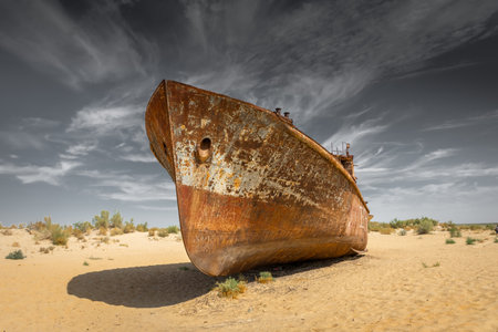 Muynak, Uzbekistan 16 August 2023 : Rusting shipwrecks on what used to be the seabed of the Aral Sea. The Aral Sea has lost significant amounts of water coverage due to excessive irrigationの写真素材