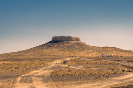 The fortress of Chilpik Kala, a tower of silence (dakhla) of the ancient Zoroastrian religion, serving as burial site in the desert, Uzbekistanの写真素材