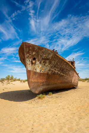 Muynak, Uzbekistan 16 August 2023 : Rusting shipwrecks on what used to be the seabed of the Aral Sea. The Aral Sea has lost significant amounts of water coverage due to excessive irrigationの写真素材
