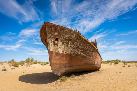 Muynak, Uzbekistan 16 August 2023 : Rusting shipwrecks on what used to be the seabed of the Aral Sea. The Aral Sea has lost significant amounts of water coverage due to excessive irrigationの写真素材
