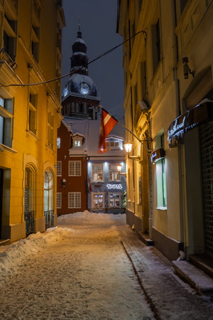 Riga, Latvia, 2 December 2023: Snowy streets of Riga at nightの写真素材