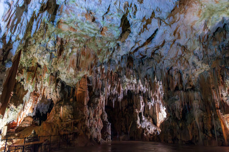 Exploring beautiful Postojna cave in Slovenia the most visited European cave. Thousands of stalagmites and stalactitesの写真素材