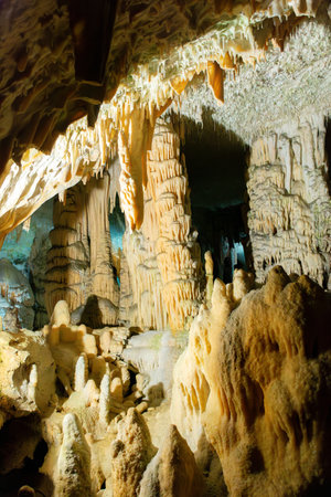 Exploring beautiful Postojna cave in Slovenia the most visited European cave. Thousands of stalagmites and stalactitesの写真素材
