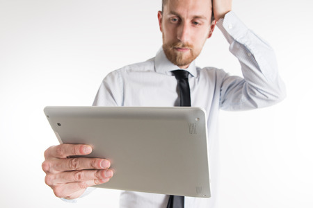 Young business man looking at his tabletの写真素材