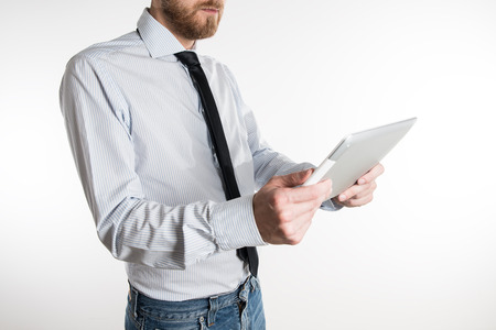 Young business man looking at his tabletの写真素材
