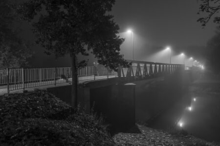 Night shot of a bridge in Regensburg with fogの写真素材
