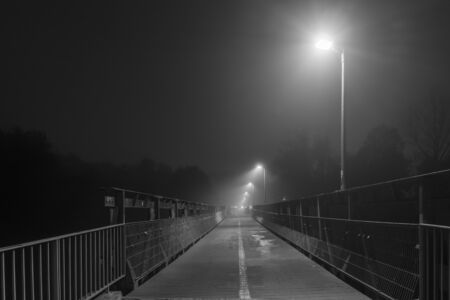 Night shot of a bridge in Regensburg with fogの写真素材