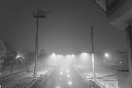 Night shot of the Protzenweiher bridge and canal europe in Regensburg with fogの写真素材
