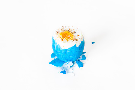 Broken and open easter egg with salt and pepperの写真素材