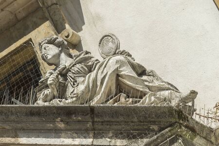 Figure on top of the entrance of the cellar of a townhallの写真素材
