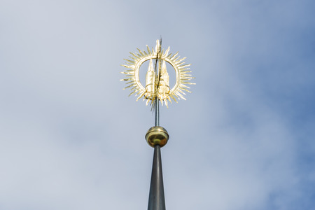 Closeup of a golden pinnacle in front of blue skyの写真素材